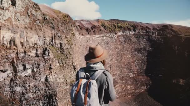 Happy female travel blogger taking photo of Vesuvius volcano crater, turning to camera and hiking down the road smiling. - Filmati, video