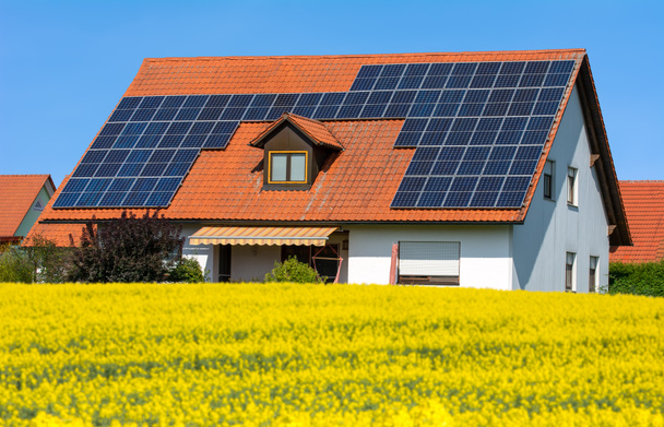 Casa moderna con células solares fotovoltaicas en el techo para la producción de energía alternativa - Foto, imagen