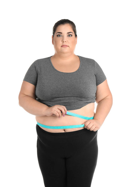 Overweight woman with measuring tape on white background - Photo, image