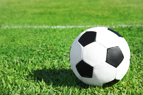 Soccer ball on fresh green football field grass. Space for text - Foto, imagen