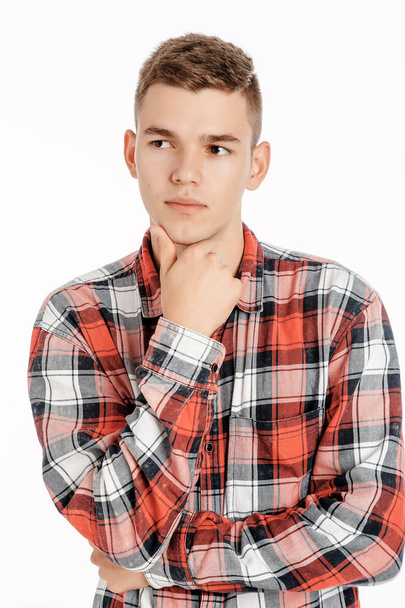Portrait of a boy in a photo studio. Young Man posing on a white background. model - Foto, afbeelding