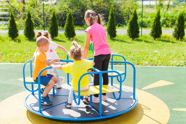 The wonderful carousel on the playground in the summer outdoors - Φωτογραφία, εικόνα