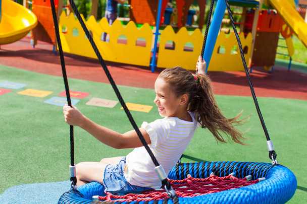 Various swings on the playground in the summer outdoors - 写真・画像