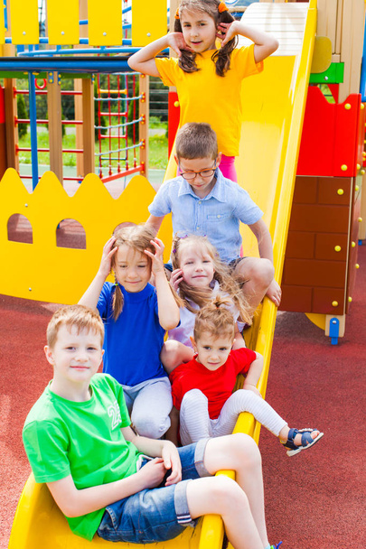 Kids traffic jam on slide in the summer outdoors - Photo, Image