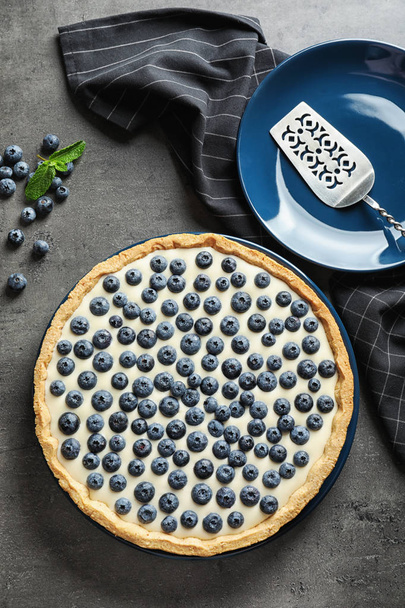 Flat lay composition with tasty blueberry cake on gray table - Fotoğraf, Görsel