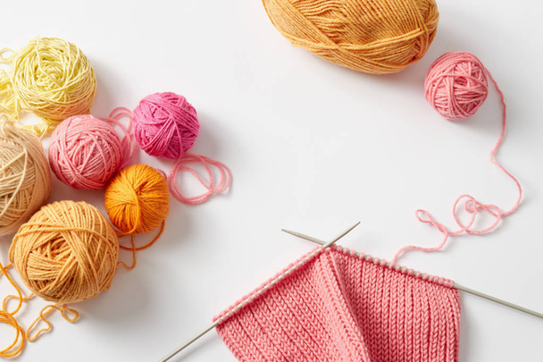 piece of knitting with balls of yarn and knitting needles - Foto, imagen