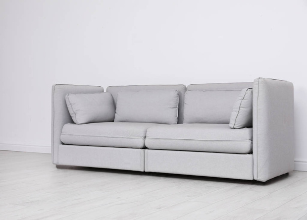 Room interior with comfortable sofa near white wall - Фото, зображення