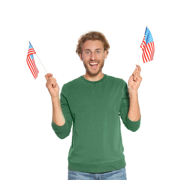 Young man with American flags on white background - Foto, Bild