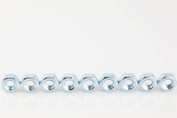Metal screw nuts on white background - Фото, изображение