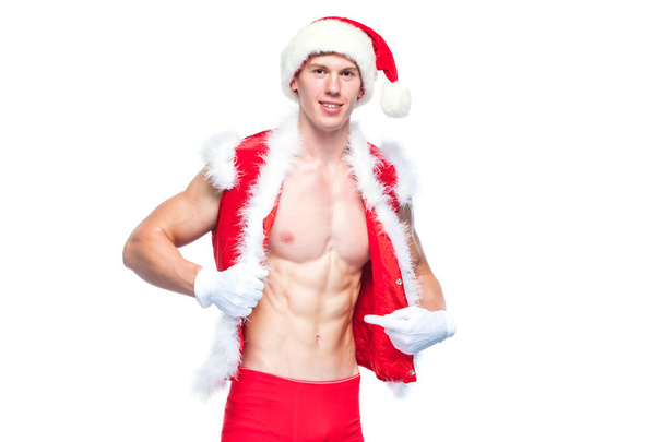 Sexy Santa Claus . Young muscular man wearing Santa Claus hat demonstrate his muscles. Isolated on white background. - Fotoğraf, Görsel