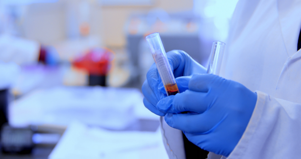 Mid section of doctor checking blood sample in blood bank 4k - Video