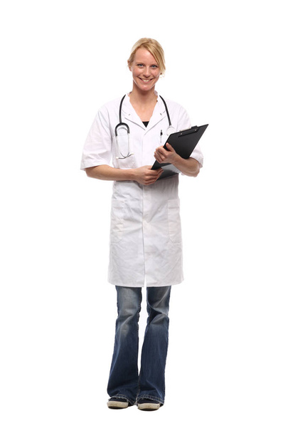 Caucasian female doctor in medical uniform with stethoscope and clipboard - Фото, зображення