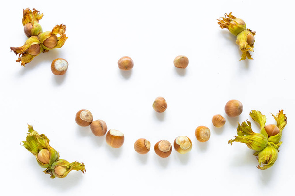 Hazelnuts on a white background smiling close-up - Photo, Image