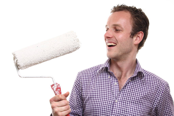 Caucasian young man with paint roller - Photo, Image