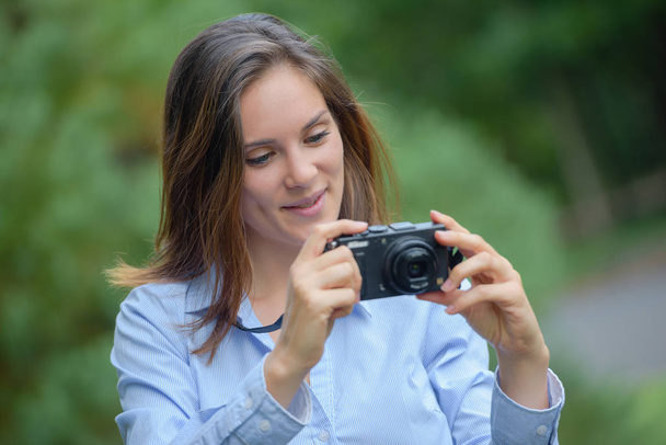 young female photographer with camera - 写真・画像