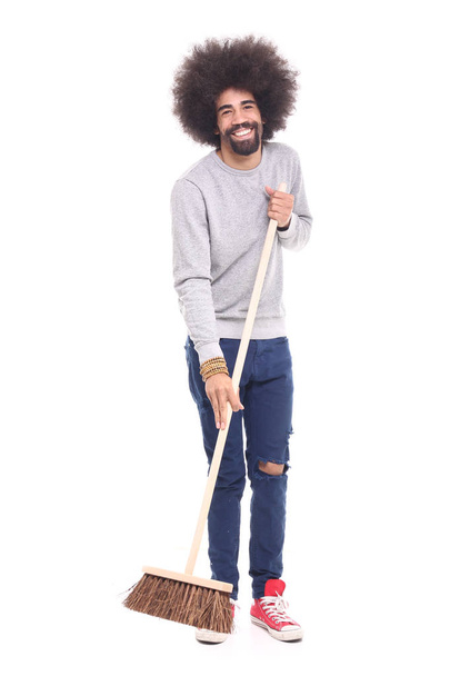 Happy black man holding brush on white background - Foto, afbeelding