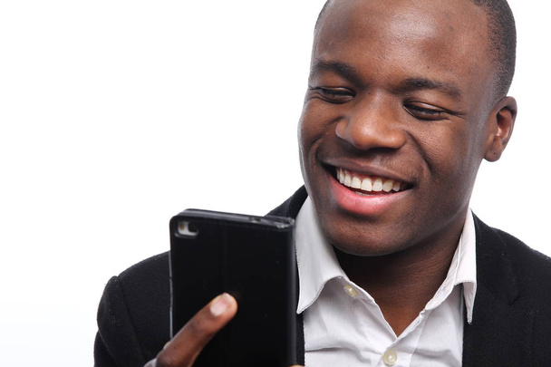 Black businessman holding a mobile phone - Foto, Imagem