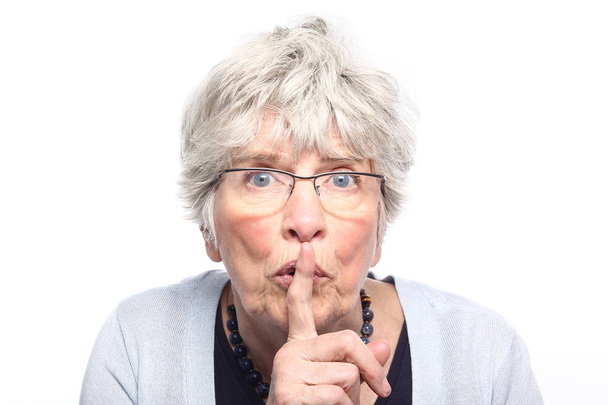 Old caucasian woman is showing silence sign - Photo, image