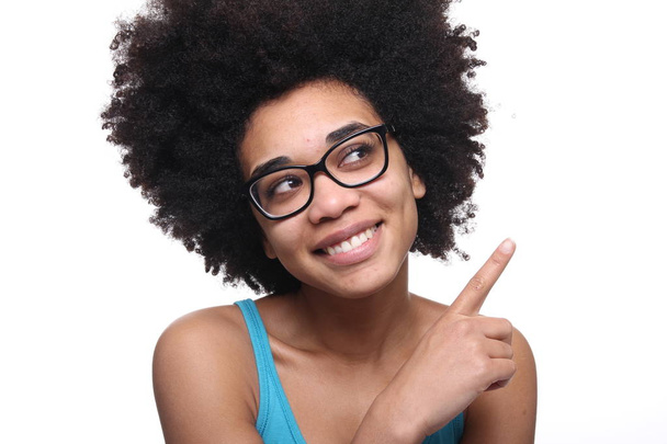 Beautiful afro-american woman is pointing to something - Foto, afbeelding