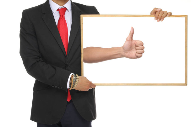 Businessman is holding blackboard with thumbs up sign - Foto, imagen