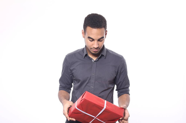 Black man with holiday gift - Foto, imagen