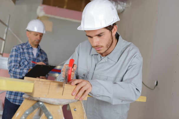carpenter with apprentice in training period - Photo, Image