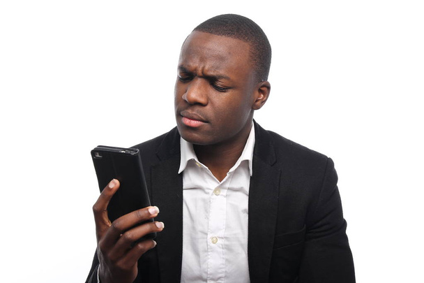 Black businessman holding a mobile phone - Foto, Imagen