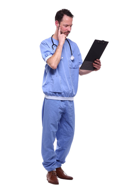 Male doctor wearing special uniform with stethoscope and clipboard - Foto, afbeelding