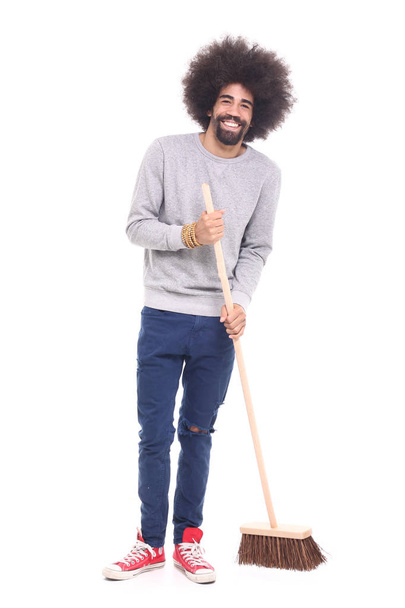 Happy black man holding brush on white background - Photo, Image