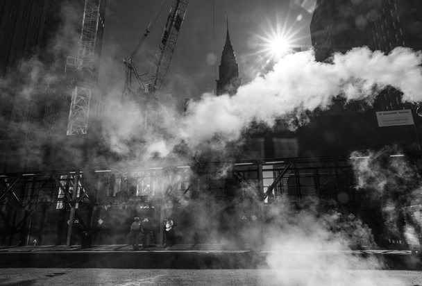 NEW YORK, USA - Sep 23, 2017: Manhattan street scene. Cloud of vapor from the subway on the streets of Manhattan in NYC. Typical view of Manhattan - Фото, изображение
