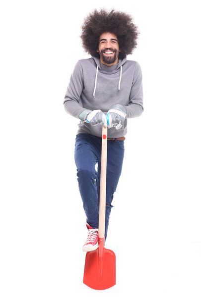 Black man holding shovel on white background - Фото, изображение