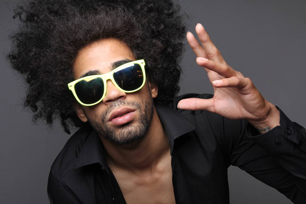 Curly black man posing in glasses - Photo, Image