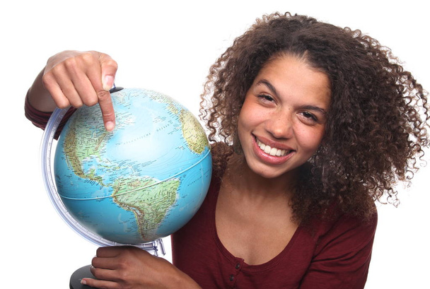 Happy black woman pointing on globe - Zdjęcie, obraz