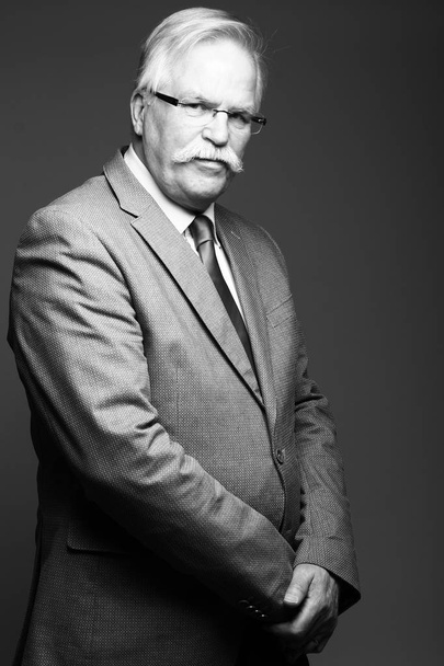 Serious caucasian old businessman on black and white tone - Фото, зображення