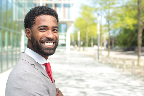 Smiling black businessman outdoors - 写真・画像
