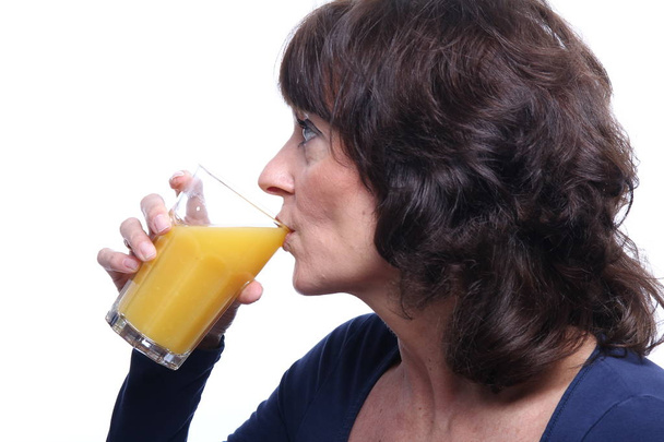 Adult woman with cup of juice on white background - Fotoğraf, Görsel