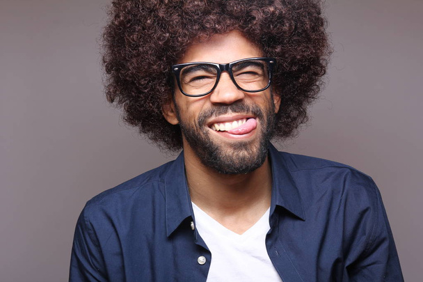 Happy black man in glasses posing - 写真・画像