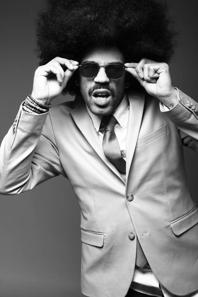 Black businessman in glasses posing on black and white tone - Foto, Imagem