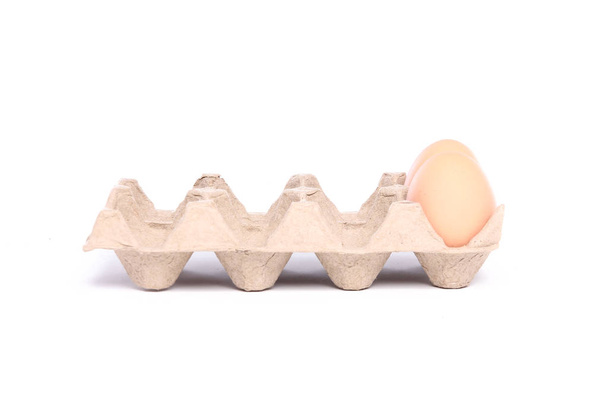 Eggs in cardboard package on white background - Zdjęcie, obraz