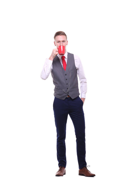 Caucasian young man is drinking coffee or tea  - Photo, image