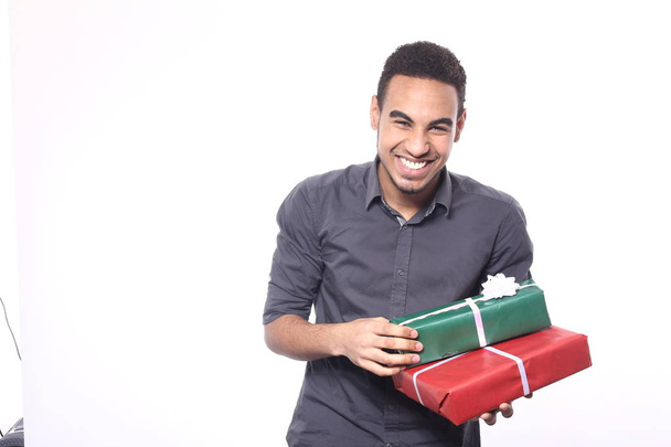 Black man with holiday gifts - Фото, изображение