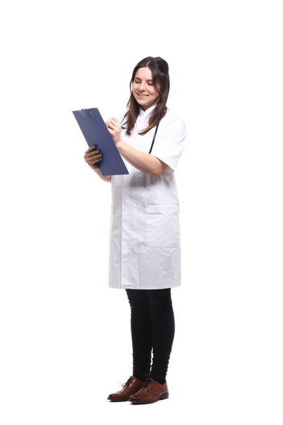 Caucasian female doctor in medical uniform with stethoscope and clipboard - Foto, Bild