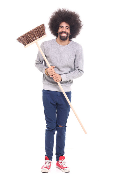 Happy black man holding brush on white background - Photo, Image