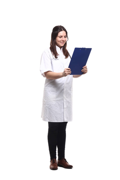 Caucasian female doctor in medical uniform with stethoscope and clipboard - 写真・画像