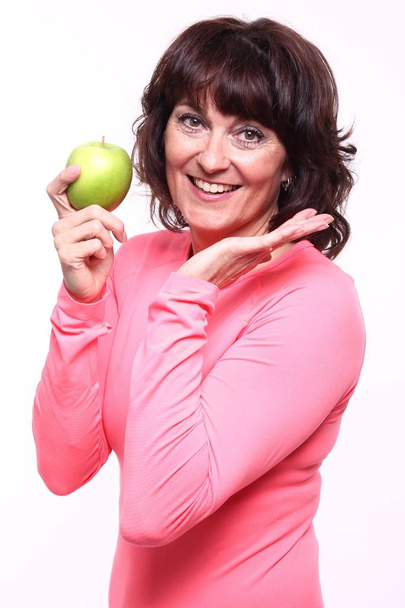 Adult woman holding an apple - Fotó, kép