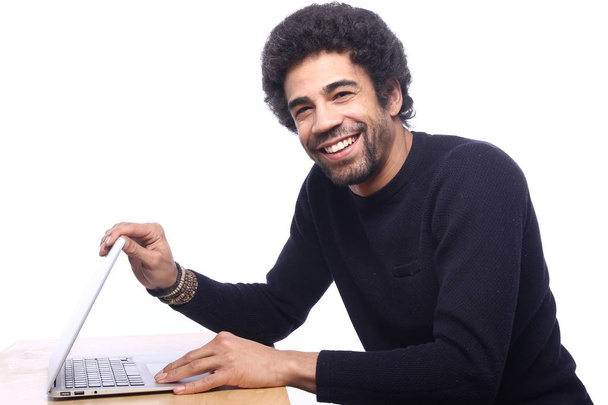 Black man using a laptop computer on table - Fotografie, Obrázek
