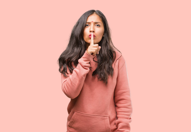 Портрет фітнесу молодої індійської жінки, що зберігає таємницю або просить мовчання
 - Фото, зображення