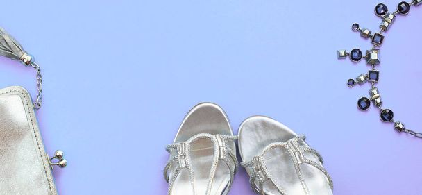 Banner Set of fashion accessories flat lay shoes handbag necklace jewelry silver color on purple background. Top view copy space - Photo, Image