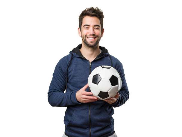 felice giovane uomo in possesso di un pallone da calcio isolato su sfondo bianco
 - Foto, immagini