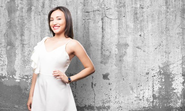 happy asian woman in white dress against grey grunge background - Фото, зображення